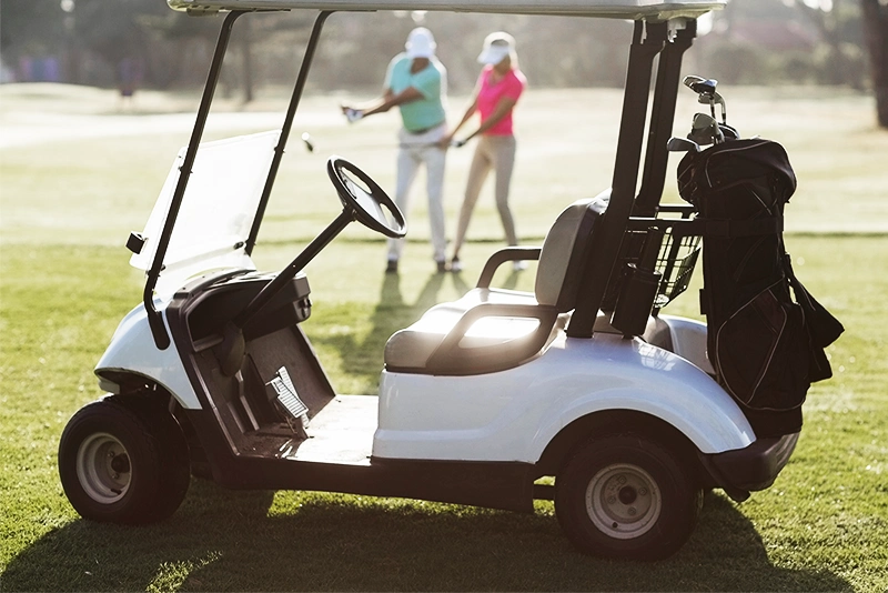 Electric golf cart powered by premium VMAX deep cycle GC2 AGM or LiFePO4 lithium batteries on a sunny fairway.